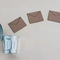 Cartoon Tiny Letters Going into a Tiny Trash