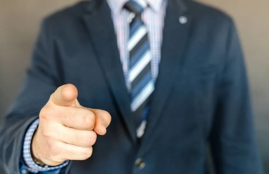 Man in a Suit Pointing a Finger at You