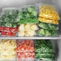 Various Vegetables and Potatoes in Bags in the Freezer