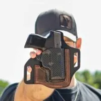 A-Man-Holding-a-Gun-in-a-Holster
