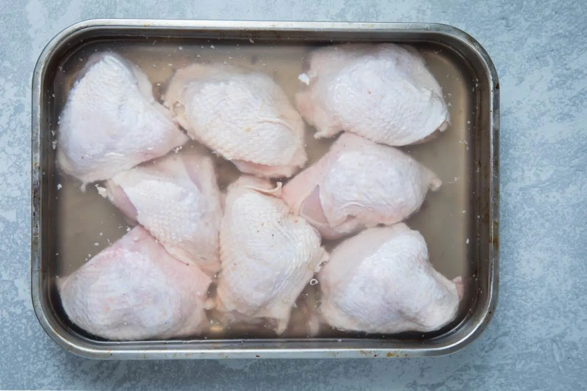 Brined chicken thighs in a tray