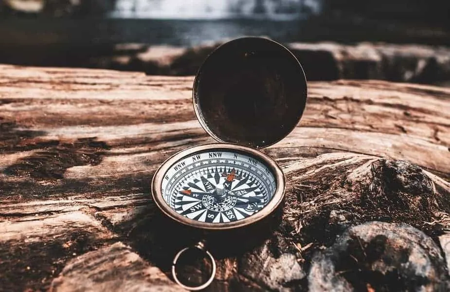 Compass on a Rock With a Waterfall in the Background