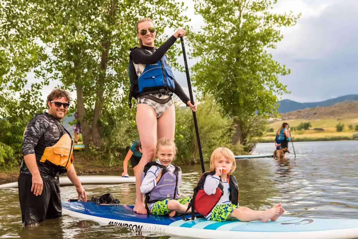 A Family Paddleboarding on a Lake