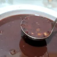A-Bowl-of-Runny-Red-Beans-With-a-Ladel-Holding-Some