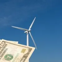 A wind turbine and dollar bills