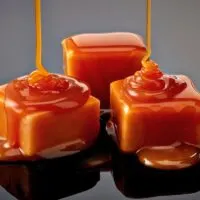 Homemade caramel candies on a black background