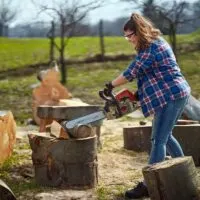 Woman-Cutting-Logs-With-a-Chainsaw