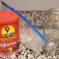 Container of Sun-Maid Raisins a Ziplock Bag and a Large Mason Jar
