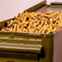 Open green ammo box full of bullets