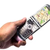Flip Phone in Hand With GPS Navigation
