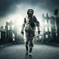 Post apocalyptic survivor in gas mask holding a handgun destroyed city in the background