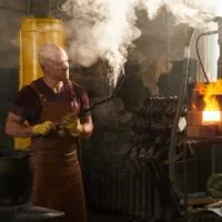 Blacksmith examining handmade knife after forging