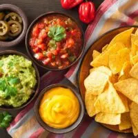 Tortilla chips with guacamole salsa and cheese dip