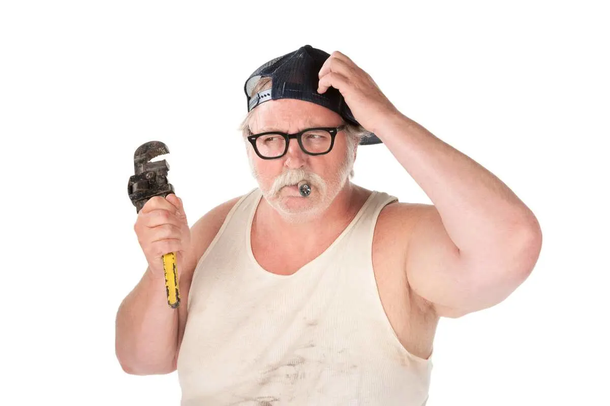 Confused Plumber Holding a Wrench