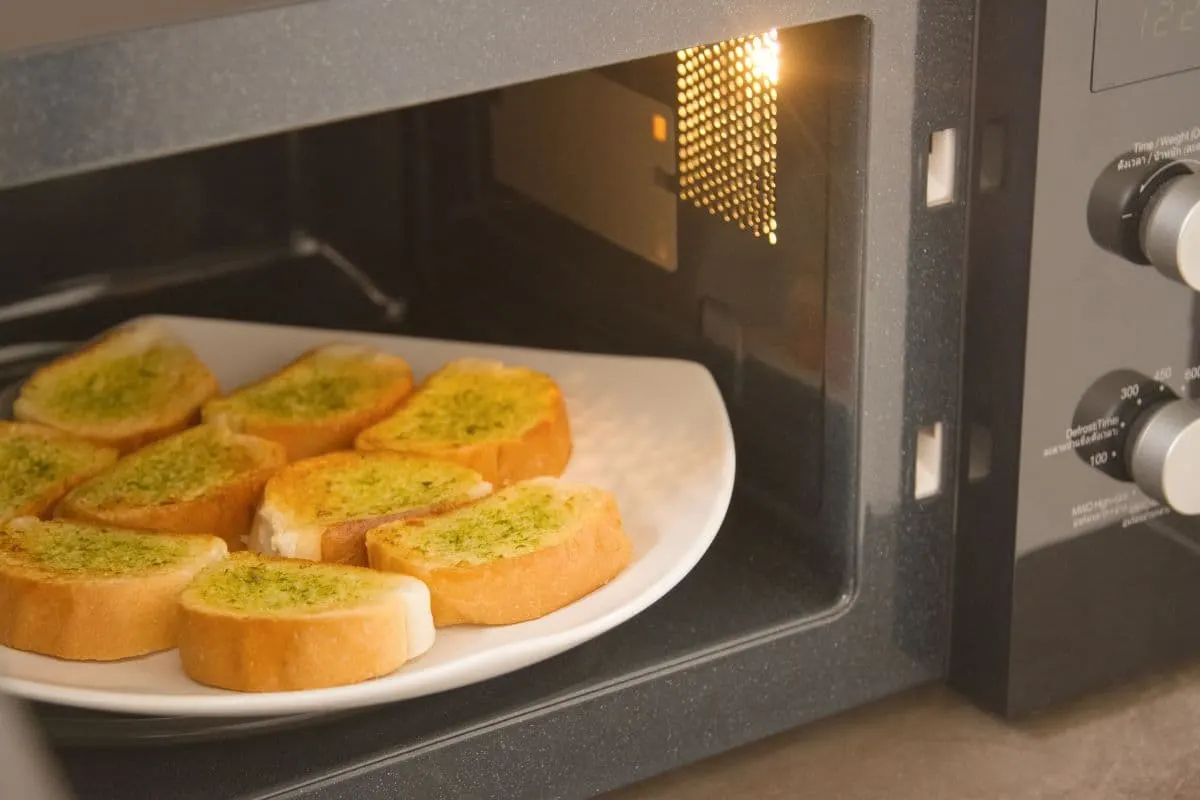 A plate of garlic bread in a microwave