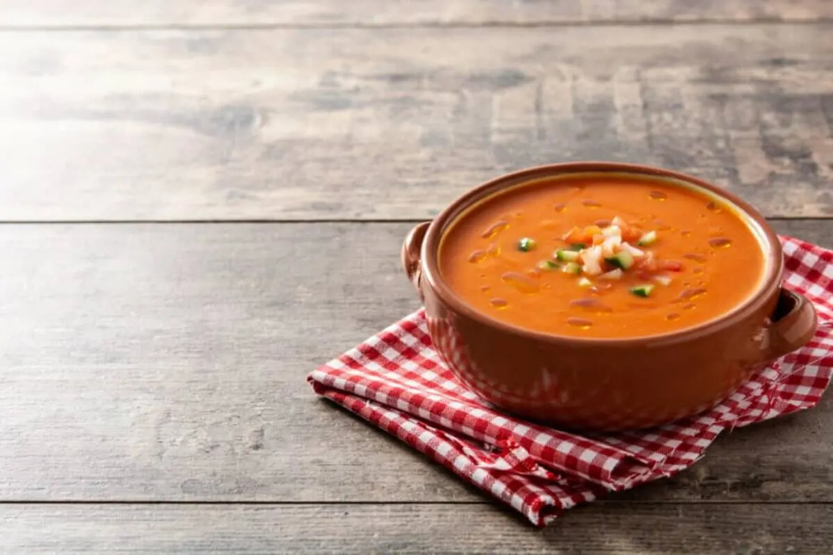 Gazpacho soup in a bowl on a wooden table