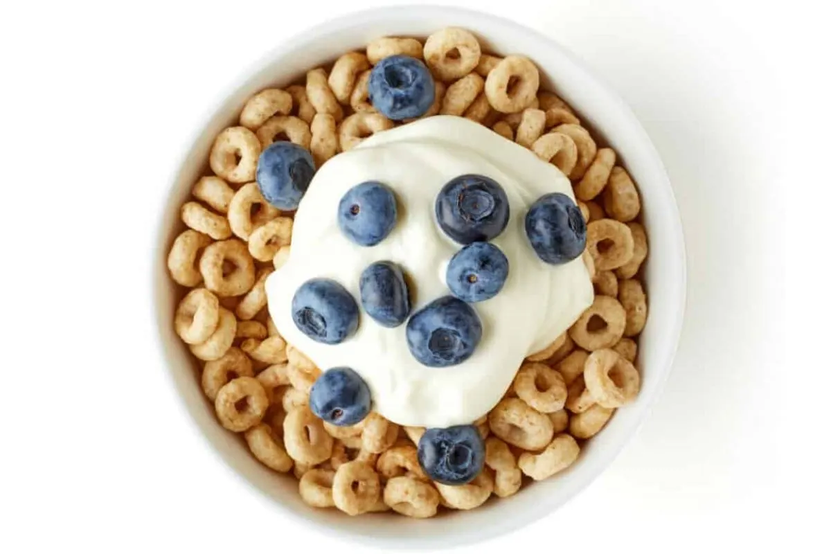 A Bowl of Whole Grain Cheerios Cereal with Blueberries and Yogurt